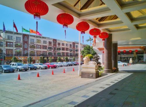 a building with red lanterns and a street with cars at Quanzhou Hotel in Quanzhou