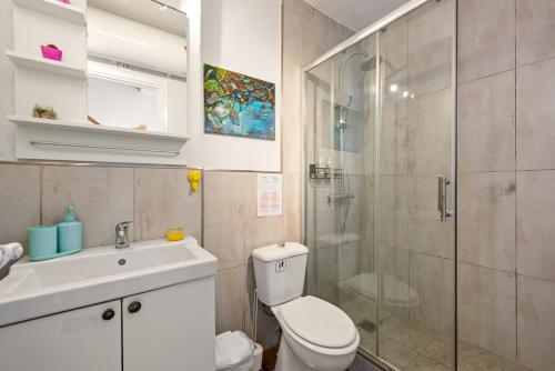 a bathroom with a shower and a toilet and a sink at Casita Villacana in Estepona