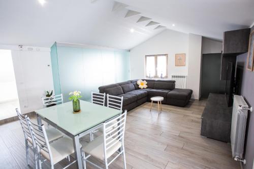 a living room with a couch and a table at Mansarda in centro - Luxury in Luino