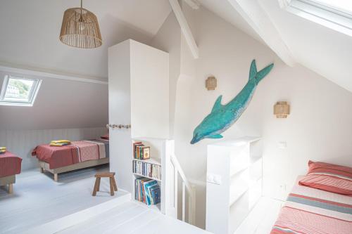 a childs bedroom with a shark decal on the wall at L'air du Large - 150m plage - Confort in Étretat