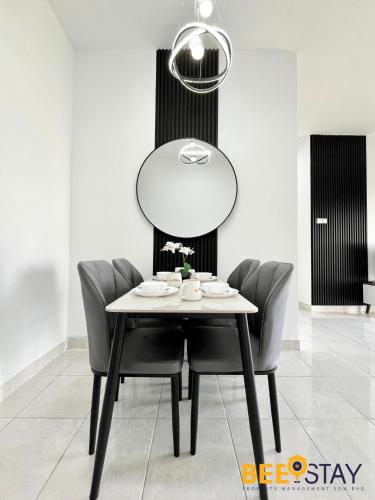 a dining room table with chairs and a mirror at Youth City Residence Family Suite KLIA AEON Mall Nilai USIM in Nilai