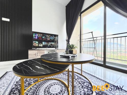 a living room with a table and a large window at Youth City Residence Family Suite KLIA AEON Mall Nilai USIM in Nilai