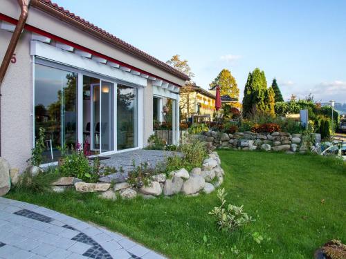 a house with a yard with a lawn sidx sidx sidx at Haus am Waldpark in Scheidegg