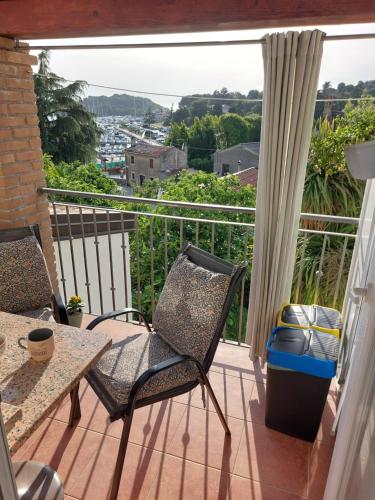 a balcony with two chairs and a table at Apartman Karo in Vrsar