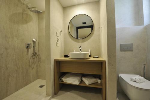 a bathroom with a sink and a toilet and a mirror at Terra Vinum in Neméa