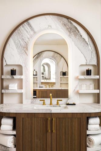 a bathroom with a sink and an archway with towels at Grand Hyatt Scottsdale Resort in Scottsdale