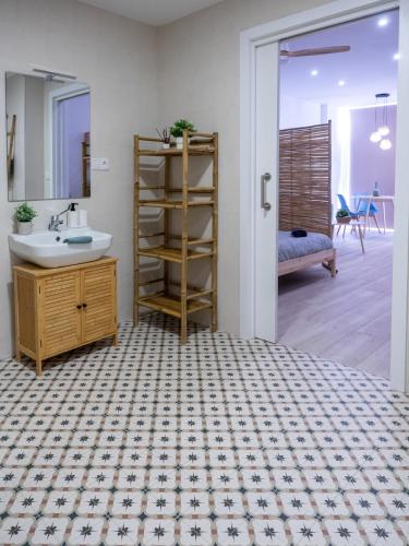 a bathroom with a sink and a mirror at Boho Beach Flats in Valencia