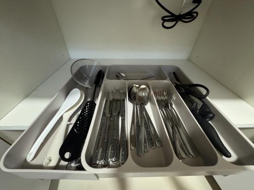 a drawer filled with utensils in a kitchen at Hiraya Solana in Boracay