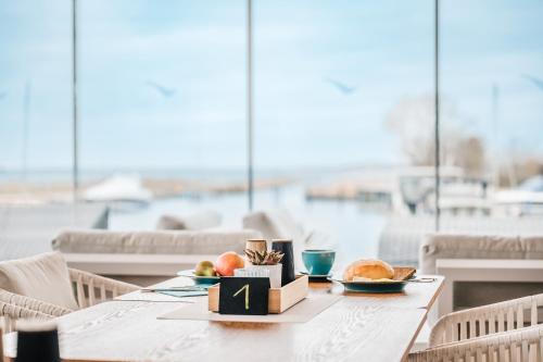 a table with two plates of food on it at Marina Martinshafen in Sassnitz