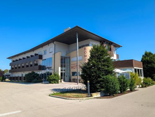 a large building with a tree in front of it at Hotel Römerhof in Tulln