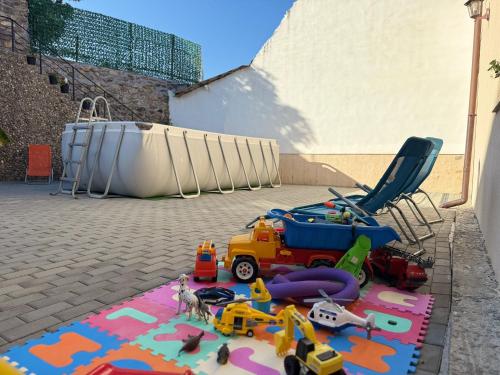 a pile of toys on a rug next to a chair at Casa Adelin in Eşelniţa