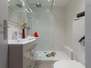 a white bathroom with a sink and a toilet at L'Azur Promenade in Nice