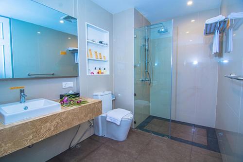 a bathroom with a sink and a shower at Sakura Residence & Hotel in Yangon