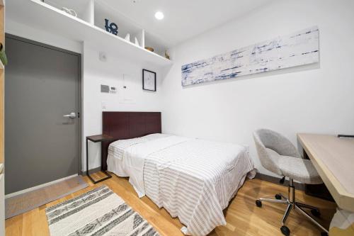 a small bedroom with a bed and a desk and a desk at Corporate Style Studio Near State House in Boston
