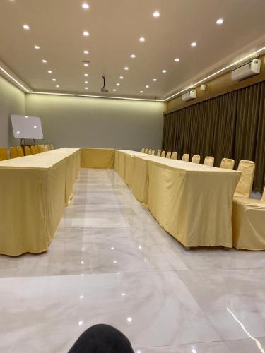 a row of tables and chairs in a room at HOTEL DOUBLE CROWN Mumbai AIRPORT T2 in Mumbai