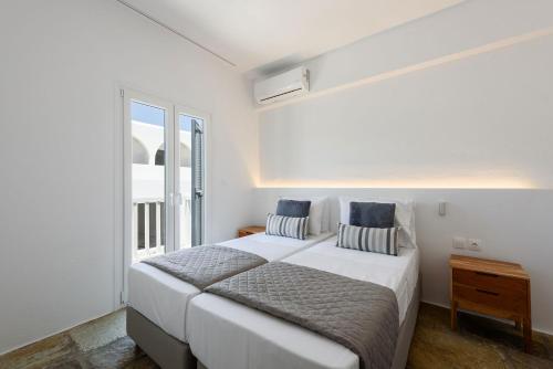 Ένα ή περισσότερα κρεβάτια σε δωμάτιο στο Phaedrus Living Paros Cycladic Residences 9