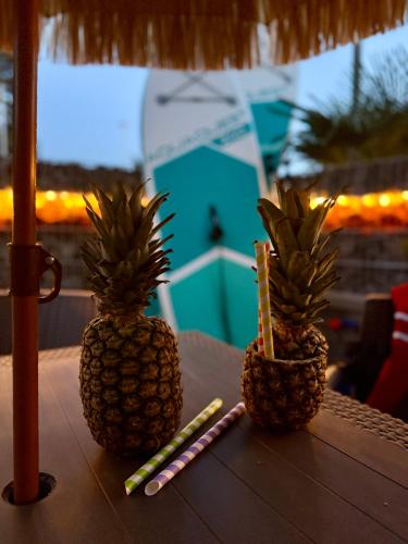 two pineapples sitting on top of a table with candles at Ambre Mare Pobierowo - Noclegi ze śniadaniem i basenem in Pobierowo