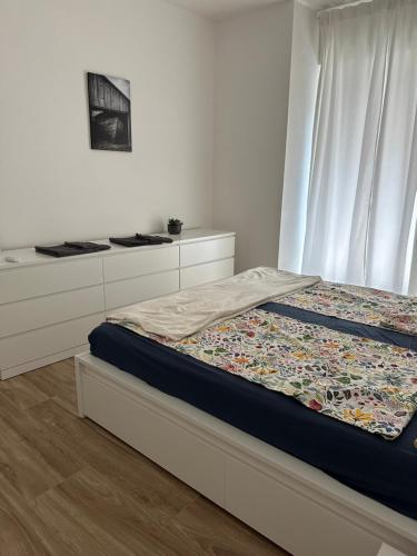a bedroom with a bed with white cabinets and a window at AP Casa Sarnico in Sarnico