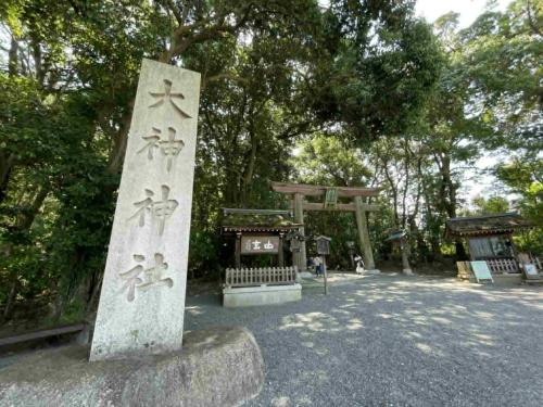 a torii gate and a statue in a park at 宿Joan in Sakurai