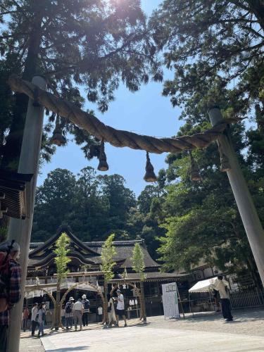 a group of people standing in front of a temple at 宿Joan in Sakurai