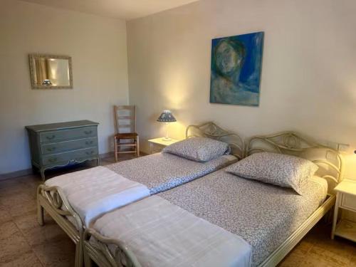 a bedroom with two beds and a dresser and a painting at Holiday Home Côte d'Azur in Mougins