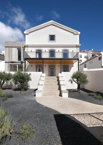 a large white house with stairs in front of it at Villa Sofia Cascais in Cascais