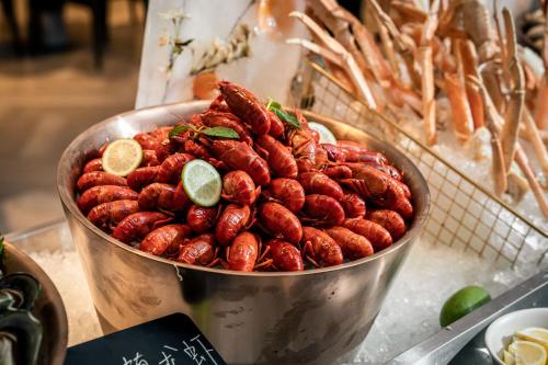 a large metal bowl filled with lots of food at Crowne Plaza Hangzhou Riverside by IHG in Hangzhou
