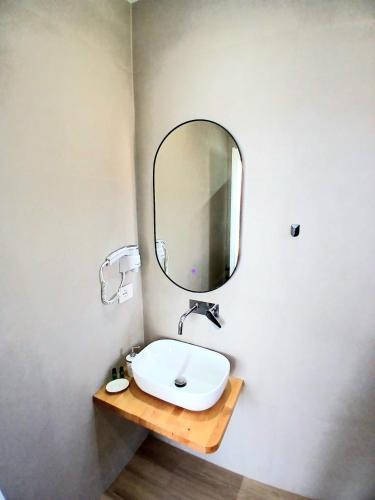 a bathroom with a sink and a mirror on the wall at Villa Saral Mar in Sarandë