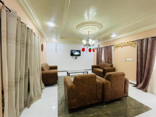a living room with two chairs and a couch at Hotel Résidences des Hotes in Kribi