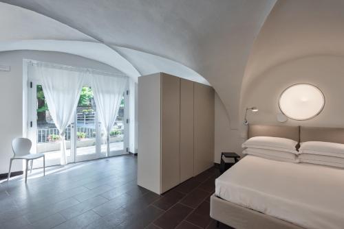 Postel nebo postele na pokoji v ubytování Hotel Rivalago