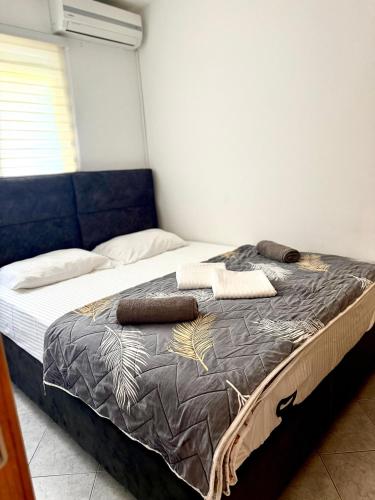 a large bed in a room with a blue couch at Kristal Rafailovici in Rafailovici
