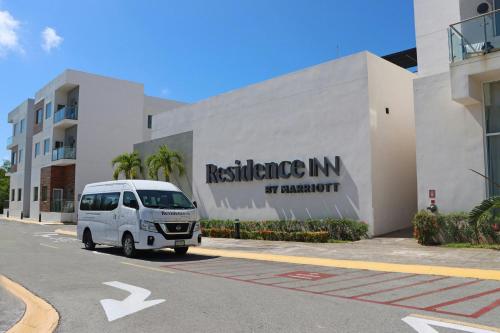 a white van parked in front of a building at Residence Inn by Marriott Cancun Hotel Zone in Cancún
