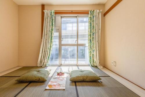 Ένα ή περισσότερα κρεβάτια σε δωμάτιο στο Ikebukuro Base