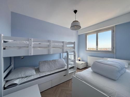 une chambre avec deux lits superposés et une fenêtre dans l'établissement Appartement T3 au 6e étage avec balcon et vue mer - FR-1-197-200, à Les Sables-dʼOlonne