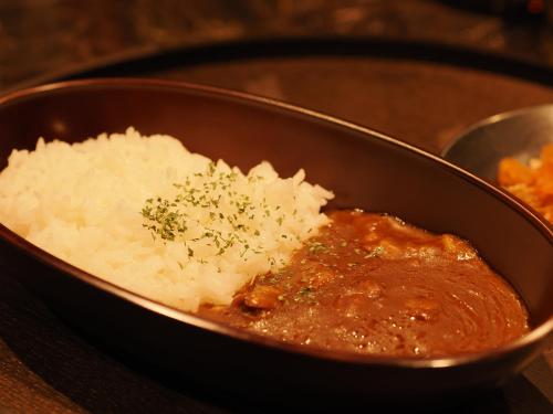 a bowl of food with rice and sauce at Sauna Hotel Gifu in Gifu