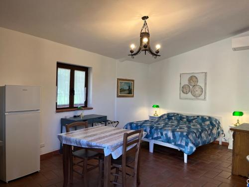 a bedroom with a bed and a table and a dining room at MUSEO GAR-AgriHotel in Certosa di Pavia