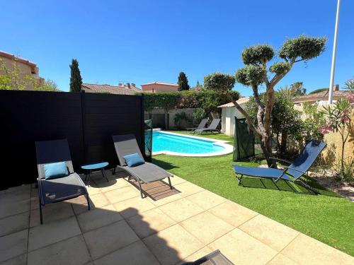 une cour avec des chaises et une piscine dans l'établissement Villa 3 étoiles avec piscine privée, 500m de la plage, 4 chambres pour 6-8 pers. au Grau-du-Roi - FR-1-307-157, au Grau-du-Roi