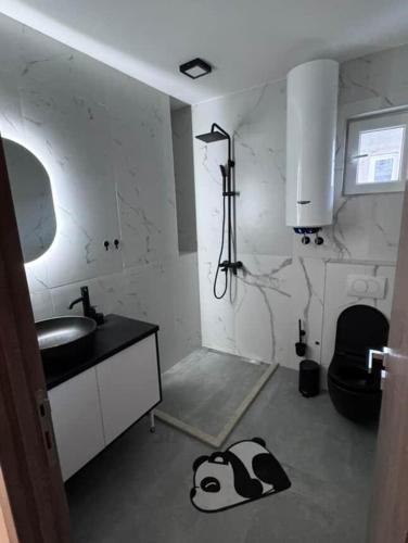 a kitchen with a sink and a cow on the floor at Apartman Andrija in Igalo