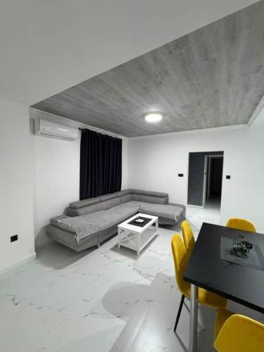 a living room with a couch and a table and chairs at Apartman Andrija in Igalo