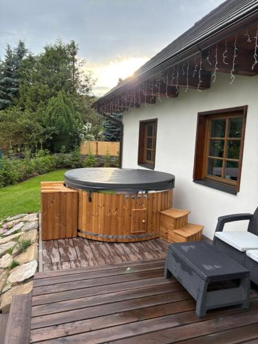 a deck with a hot tub on a house at Chalupy Jesenická dvojčata in Šumperk