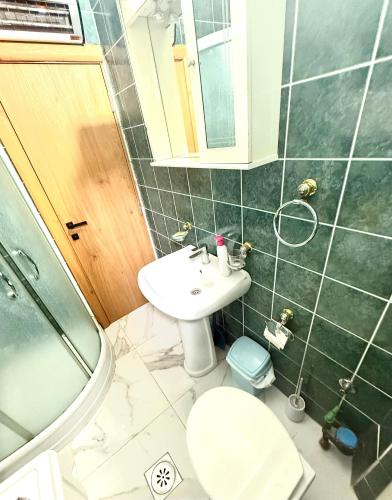 a bathroom with a sink and a toilet at Kristal Rafailovici in Rafailovici