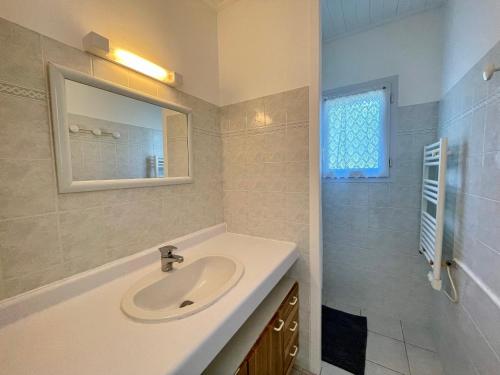 une salle de bain avec un lavabo et un miroir dans l'établissement Maison charmante proche mer avec jardin, véranda et WIFI - Quartier La Sauzaie - FR-1-231-232, à Bretignolles-sur-Mer