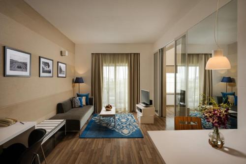 a living room with a couch and a table at Grand Mercure Bangalore - An Accor Brand in Bengaluru