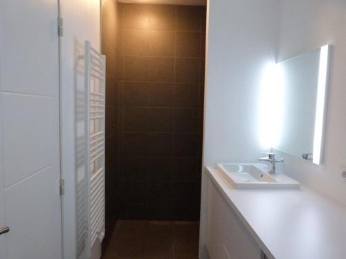 a bathroom with a sink and a mirror and a shower at Appartement en bord de mer, 2 chambres, piscine, parking, animaux admis - FR-1-194-231 in La Tranche-sur-Mer