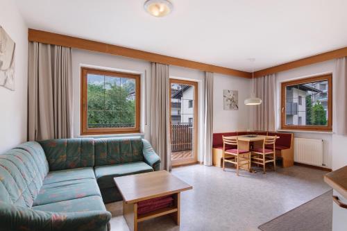 a living room with a couch and a table at New Residence Schnatzhof Schlanders in Silandro