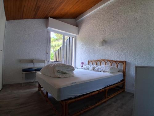 a bedroom with a bed in a room with a window at Villa Patio Duplex Calme, Proche Plage et Commerces, Idéale pour 4 Pers. - FR-1-239-237 in Seignosse