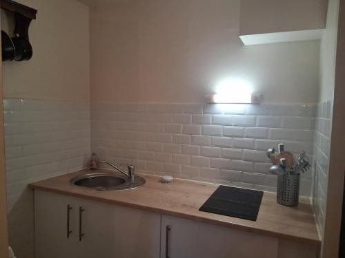 a bathroom counter with a sink and a light at Villa Patio Duplex Calme, Proche Plage et Commerces, Idéale pour 4 Pers. - FR-1-239-237 in Seignosse