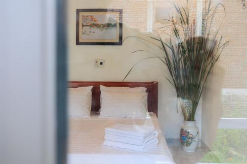 a bedroom with a bed with a vase with books at Heartfelt Hideaway in Vũ Lâm