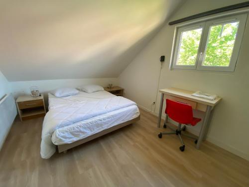 a bedroom with a bed and a desk and a window at Maison familiale avec terrasse et proche plage à Saint-Brevin-les-Pins - FR-1-364-98 in Saint-Brevin-les-Pins