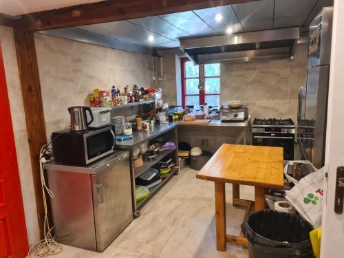 a large kitchen with a wooden table in a room at Havko, Kendereš 309, Jatov 